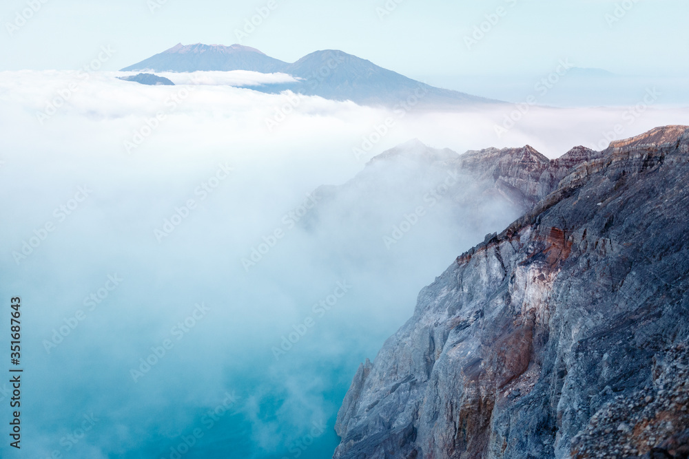 Toxic volcano Ijen on Java island, Indonesia. Foggy sunrise, another planet landscape.