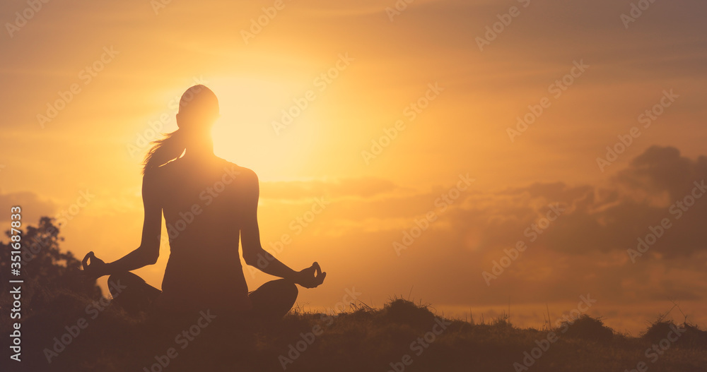 silhouette of a woman doing yoga meditating at sunset. silhouette of a woman doing yoga meditating at sunset.