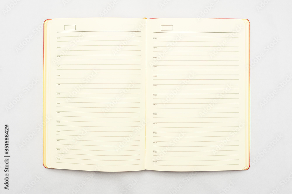Open notebook on white background, top view, copy space Open notebook on white background, top view, copy space