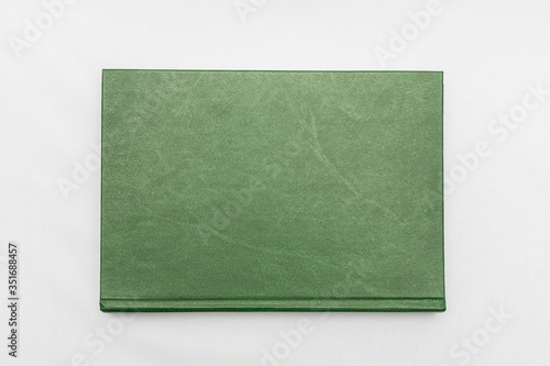 Green book, white background, top view
