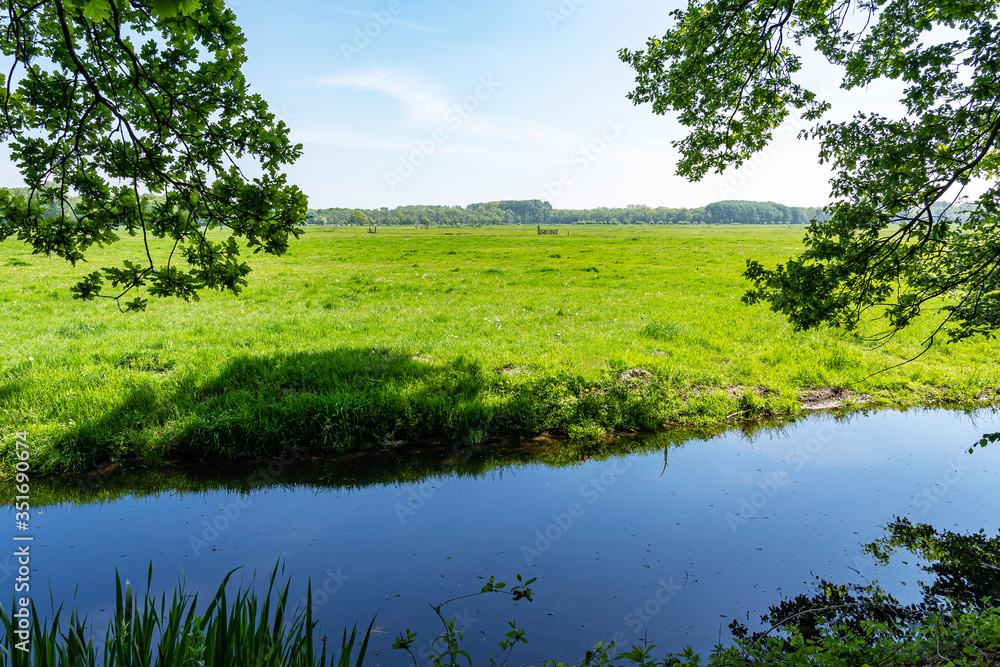 Behind this ditch are the green meadows that surround the royal estate De Horsten in Wassenaar, the Netherlands Behind this ditch are the green meadows that surround the royal estate De Horsten in Wassenaar, the Netherlands