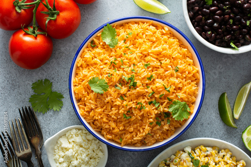 Mexican rice with tomatoes and onion served with cilantro