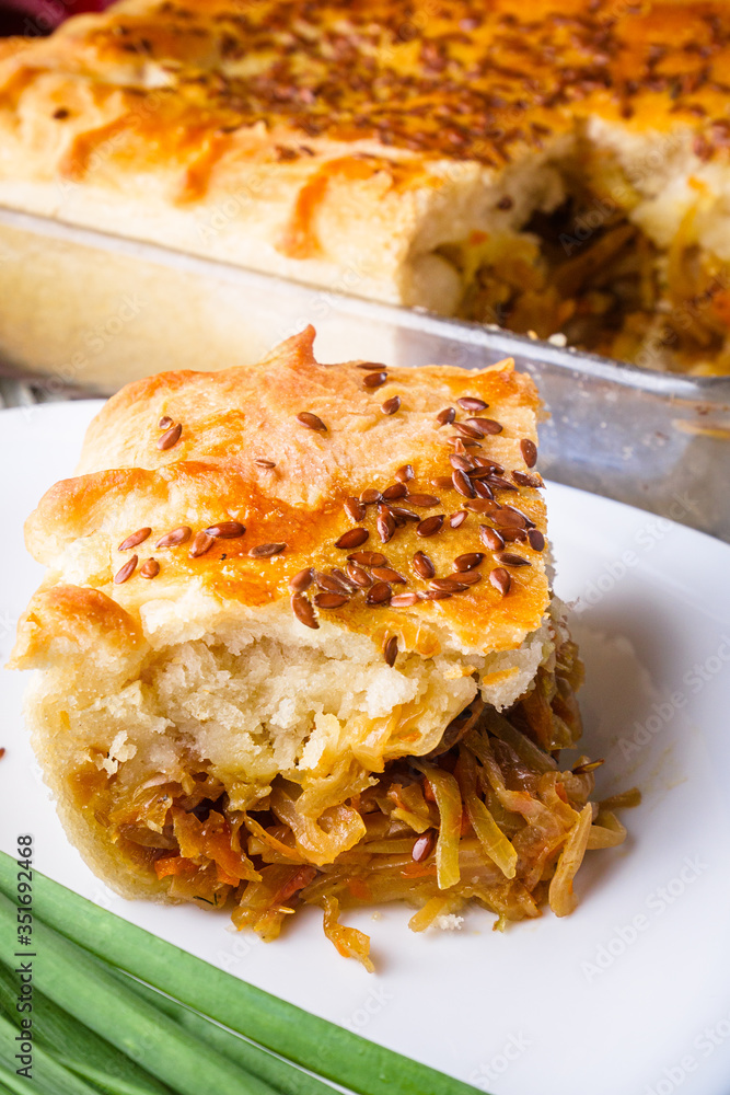 freshly baked cabbage pie on rustic wooden background freshly baked cabbage pie on rustic wooden background