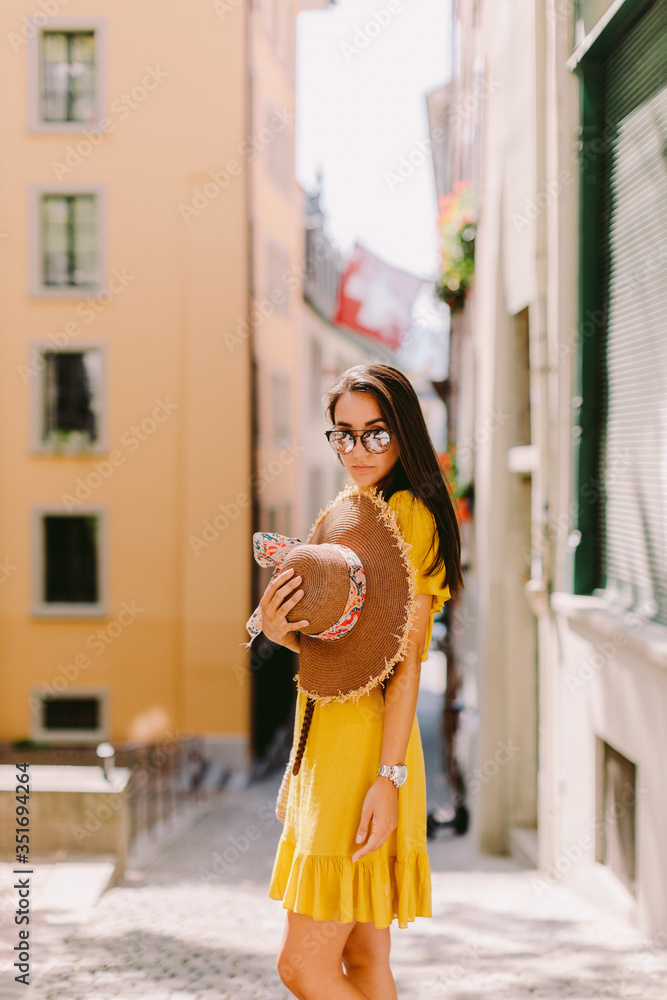 Obraz premium fashion woman wearing summer dress and sunglasses walk in street outdoors