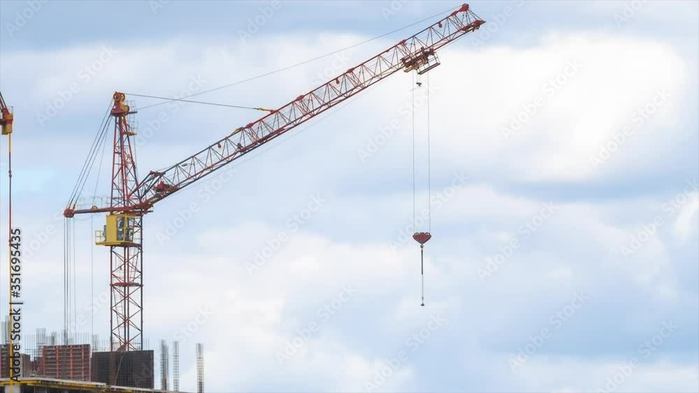 Time lapse view Modern building condominium under crane construction against blue sky Time lapse view Modern building condominium under crane construction against blue sky