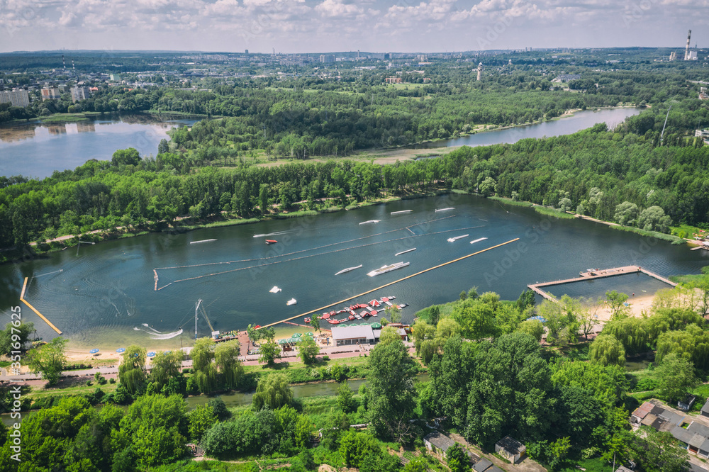 Fototapeta premium Wake cable park on lake Wakeboarding in the city aerial drone photo