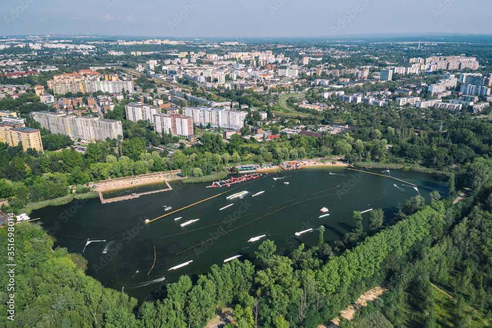 Wake cable park on lake Wakeboarding in the city aerial drone photo 