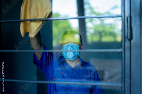 coronavirus. maintenance personnel disinfecting common areas to avoid contagion