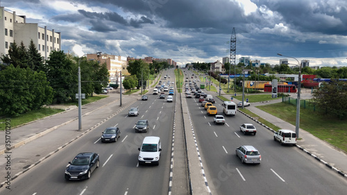 City highway before the rain. Highway under a dramatic sky with clouds. Cars under the cloudy sky.