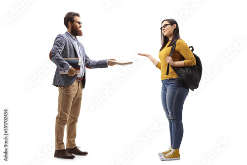 Bearded male teacher giving a book to a female student