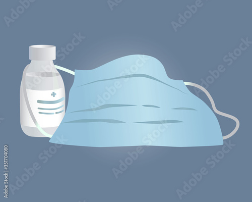 Mask and antibacterial agent for hands on a blue background.