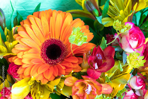 Bright orange gerbera in a bouquet of flowers. Beautiful bouquet gift for the holiday. Flowering plants as a postcard.