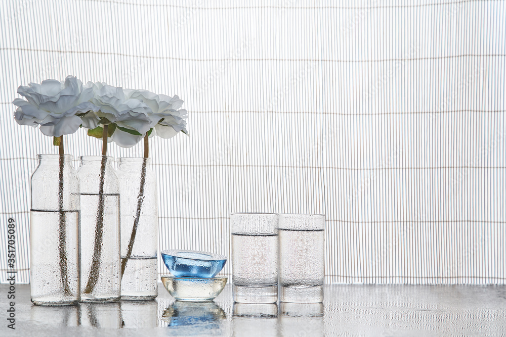 Obraz premium Glass candleholders. Aromatic oils. Treatment for body. Spa and wellness concept. Skincare. Copy space. Bamboo backdrop