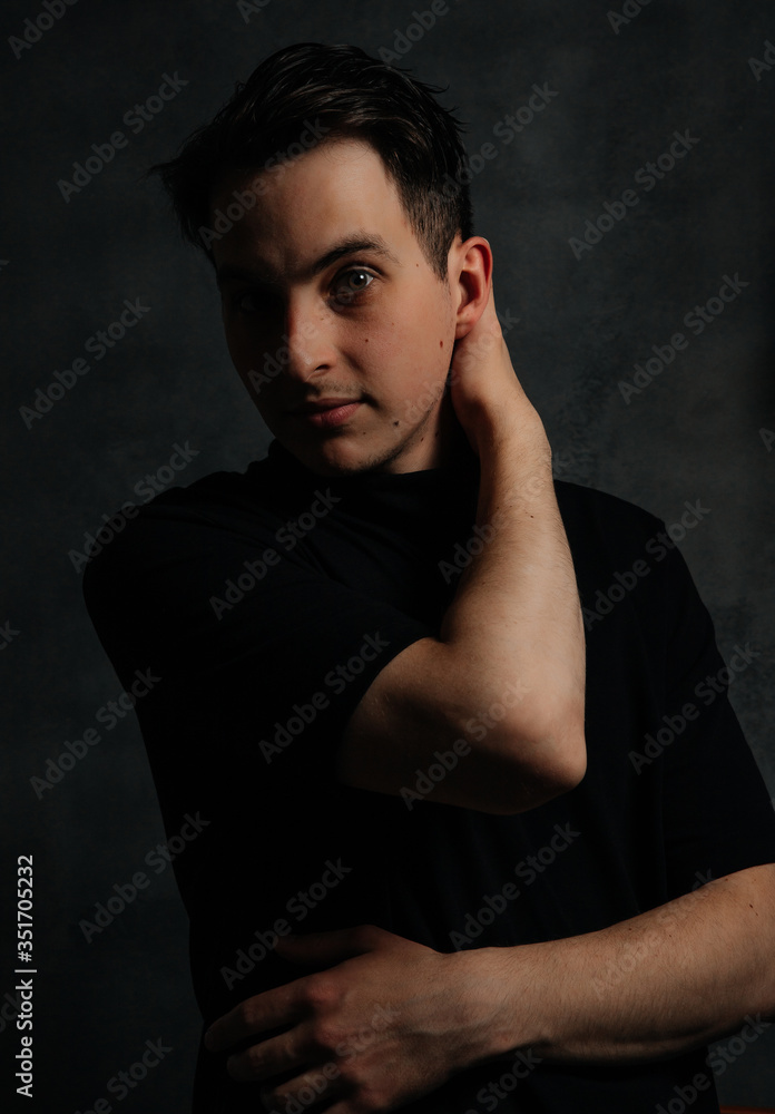 young and handsome man in studio lighting shows emotions young and handsome man in studio lighting shows emotions