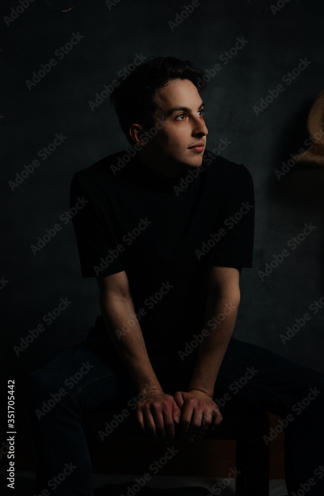 young and handsome man in studio lighting shows emotions