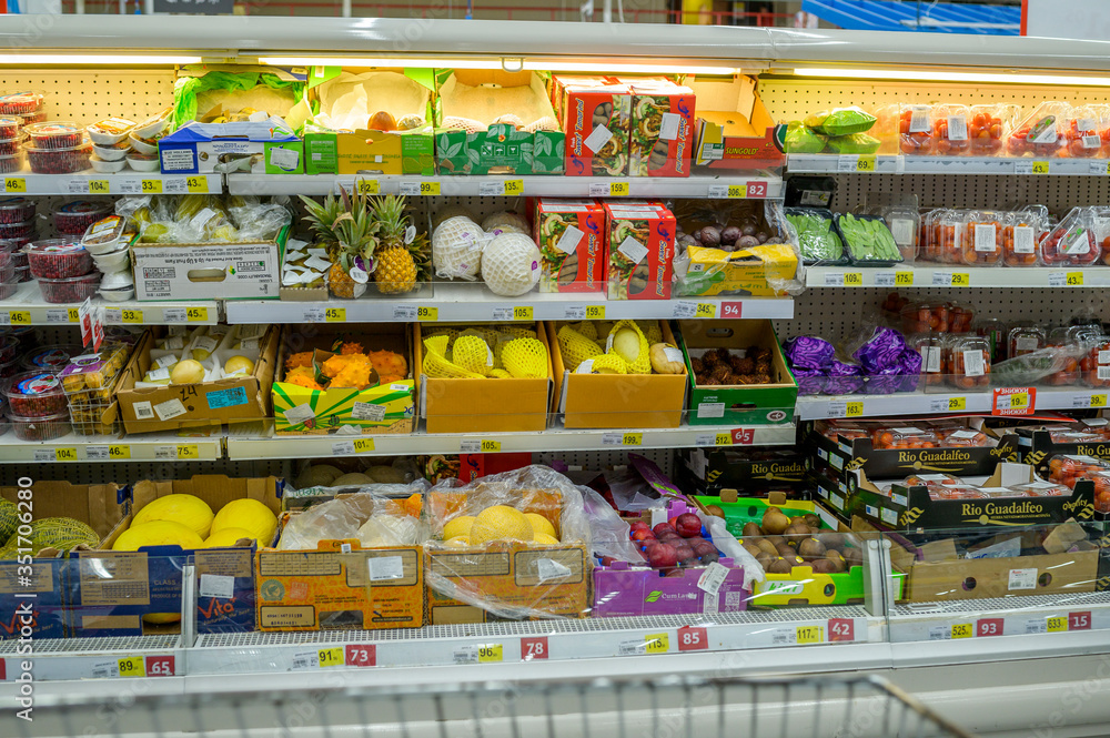 fruits and vegetables in packages on the shelves of the supermarket