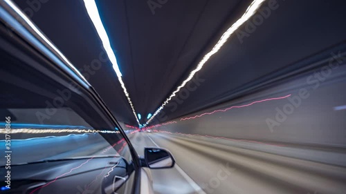 Timelapse video View from Side of Car moving in a night city, Blured road with lights with car on high speed. Concept rapid rhythm of a modern city.