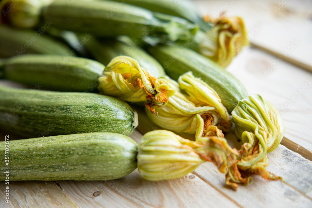 Fresh zucchini or green courgette, farm fresh produce, summer squash on a wooden table 
