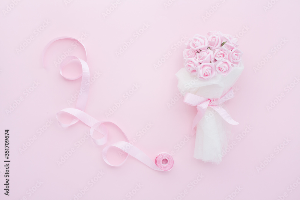 Wedding background top view of the bride's bouquet of pink roses and pink ribbon. Concept delicate female backgrounds or photos for a wedding. Wedding background top view of the bride's bouquet of pink roses and pink ribbon. Concept delicate female backgrounds or photos for a wedding.