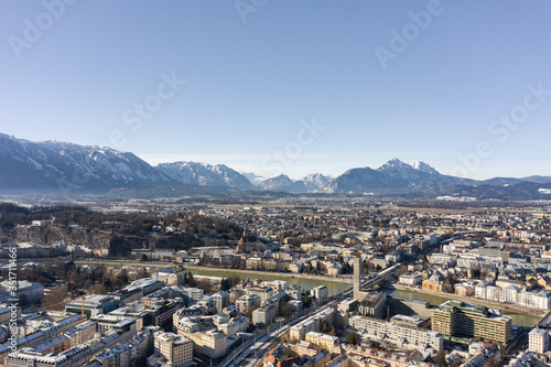 Aerial drone view of Salzburg snowy north town with view of Unesberg mountain in winter morning