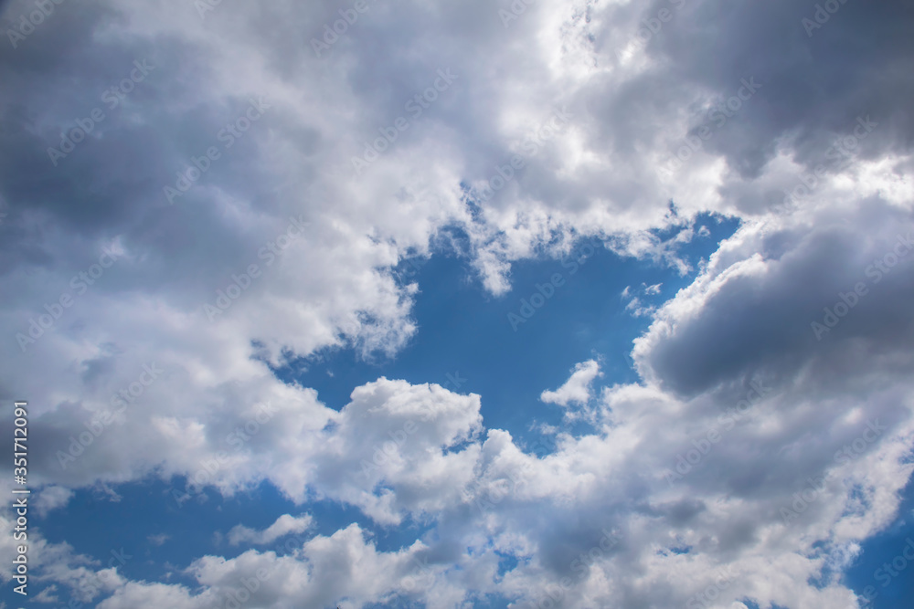 Cumulus humilis clouds in the blue sky, view from below Cumulus humilis clouds in the blue sky, view from below