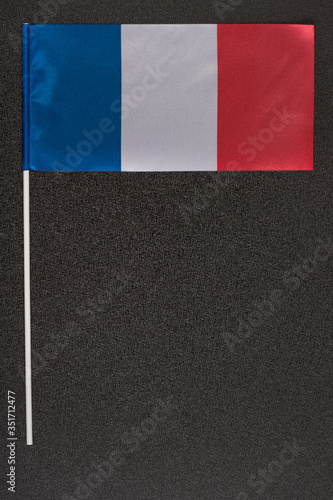 National flag of France on black background. Tri-color flag: blue white red. Vertical frame