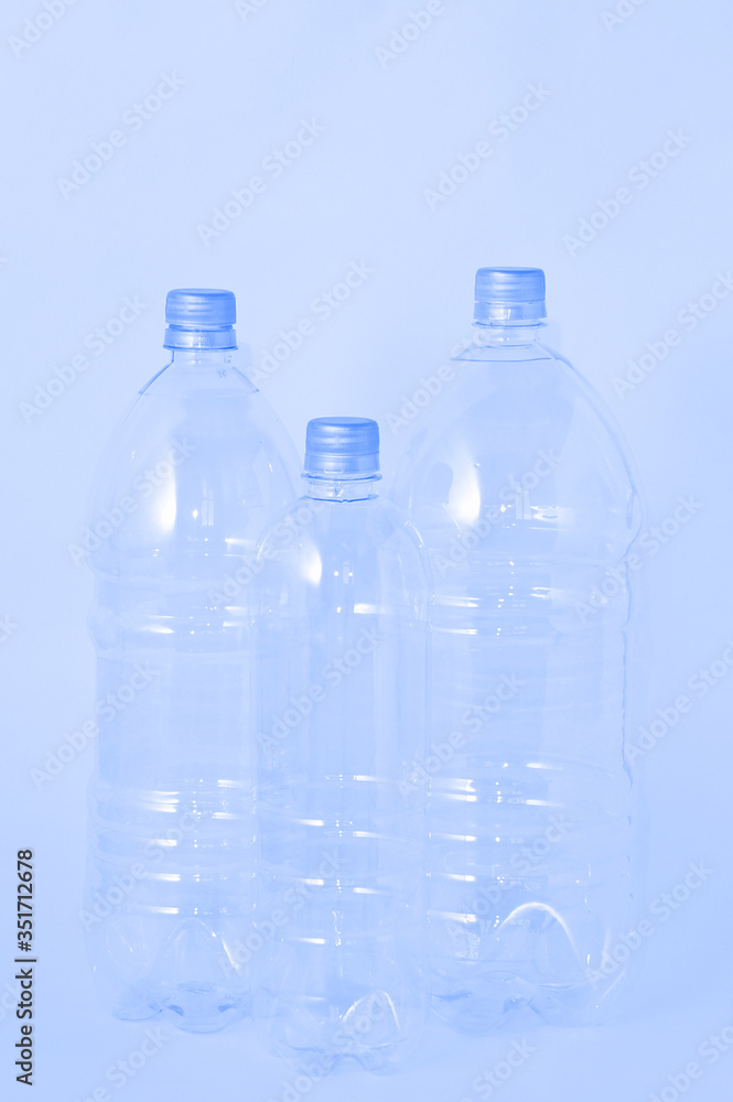 Three transparent plastic bottle with a cap of different sizes on white background. Three transparent plastic bottle with a cap of different sizes on white background.