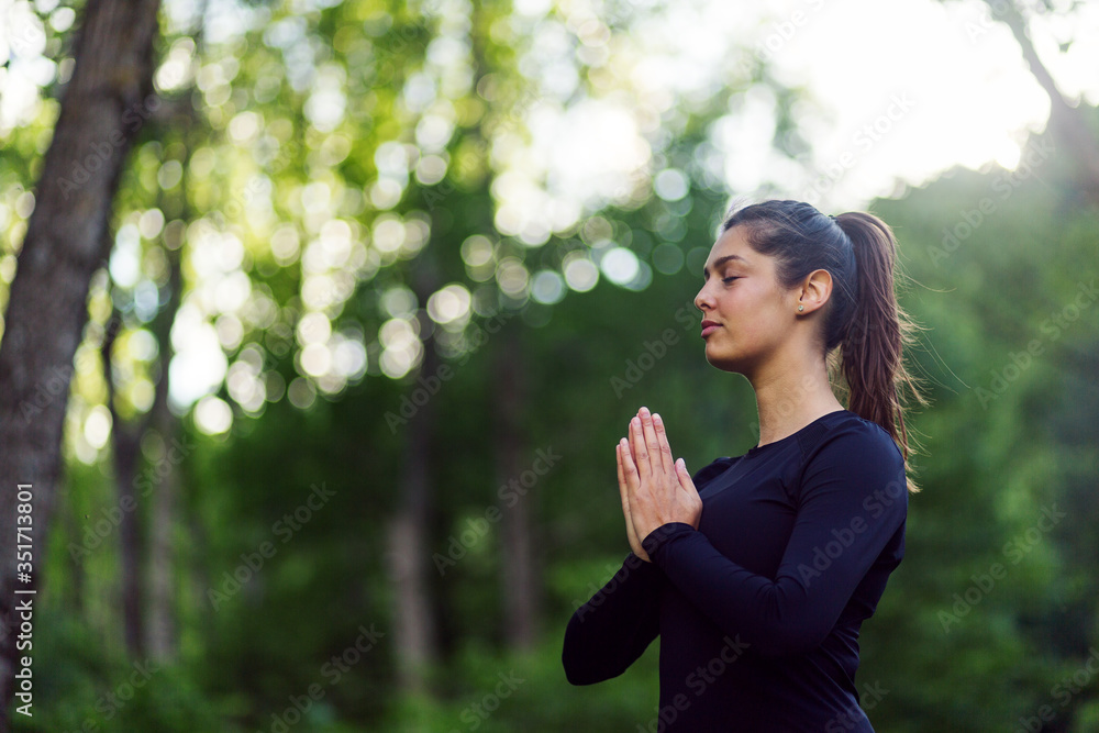 Young woman practicing yoga in a park Young woman practicing yoga in a park