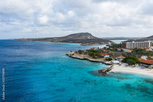Aerial view of coast of Curacao in the Caribbean Sea with turquoise water, cliff, beach and beautiful coral reef 