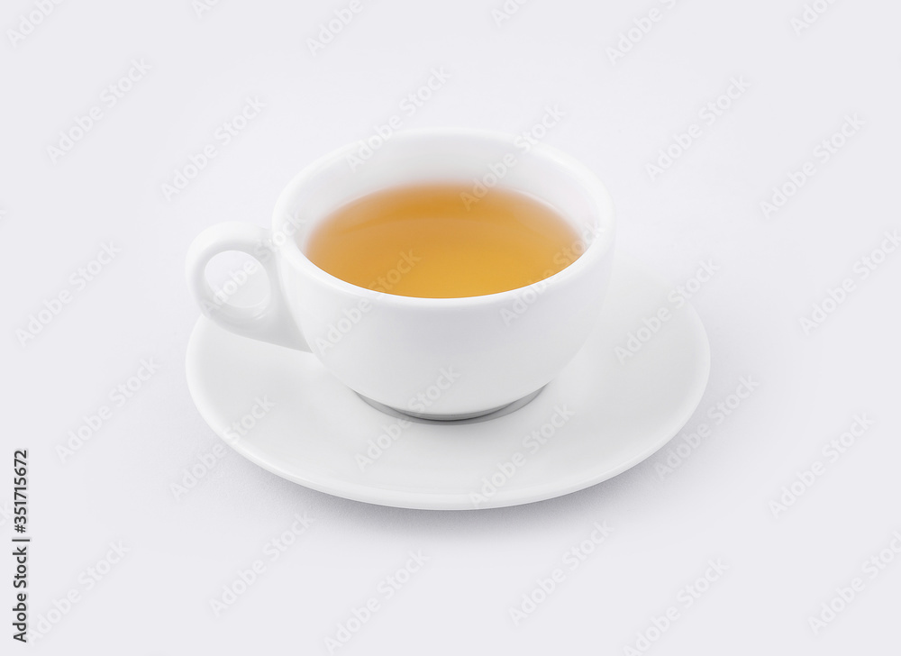 cup of green tea on a white saucer on a white background cup of green tea on a white saucer on a white background