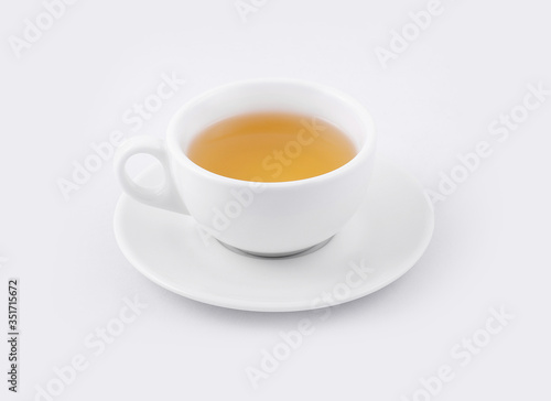 cup of green tea on a white saucer on a white background