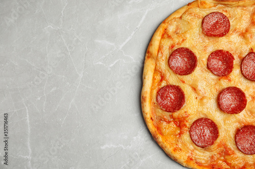 Tasty pepperoni pizza on light grey marble table, top view. Space for text