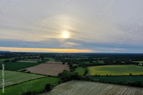 beautiful sunset of British landscape showing patchwork fields and hills in the distance 