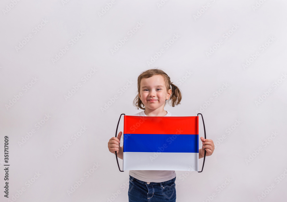 A cute young girl is holding a Russian flag on a white isolated background with space for text. A cute young girl is holding a Russian flag on a white isolated background with space for text.
