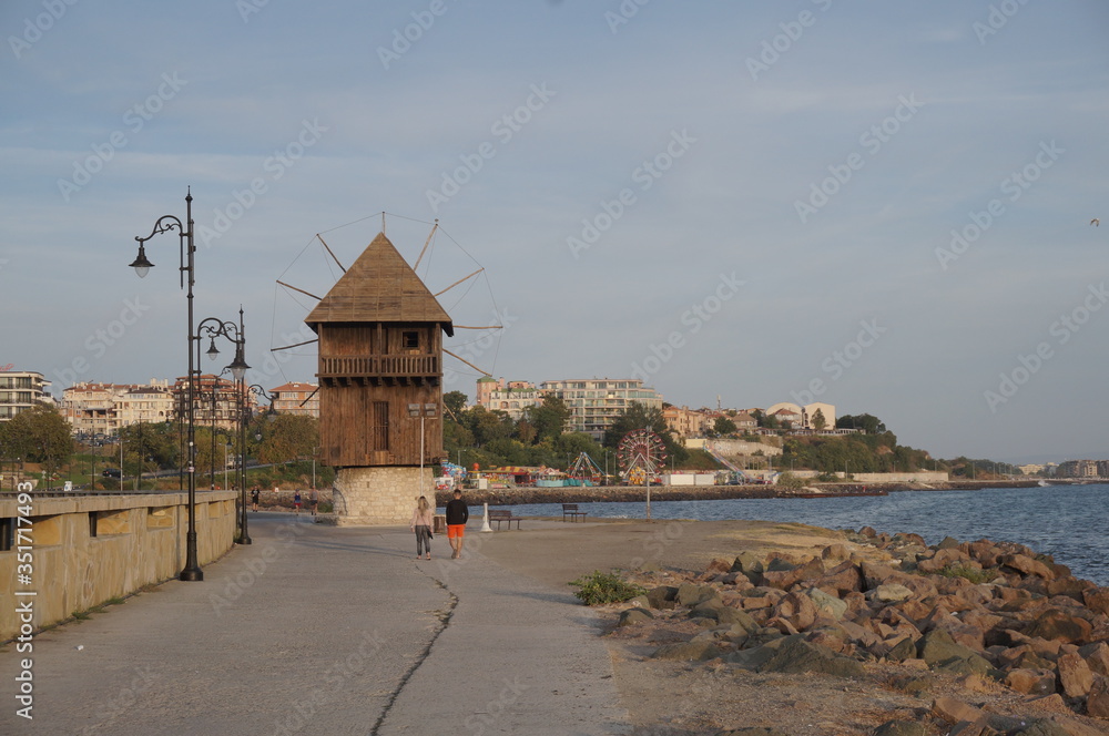 Nessebar, BULGARIA -10 September, 2019: Old wind mill at sunrise in the ancient town of Nesebar in Bulgaria. Nessebar is one of the major seaside resorts on the Bulgarian Black Sea Coast