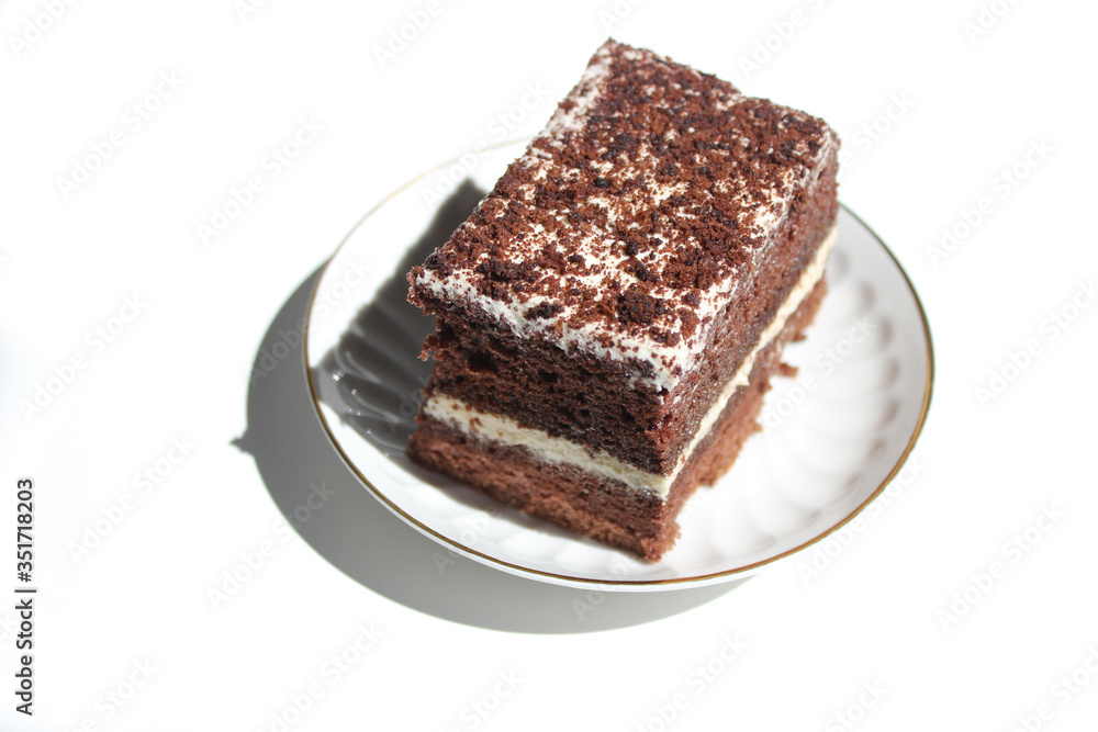 Chocolate brownie cake, dessert with white cream and topping on a light background Chocolate brownie cake, dessert with white cream and topping on a light background