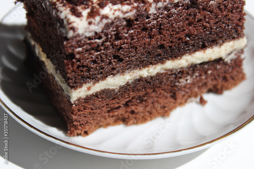 Chocolate brownie cake, dessert with white cream and topping on a light background