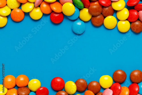  sweet colored candy close up on blue back ground with copy space for text