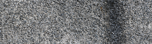 Panoramic texture of old gray concrete wall. Old rough plastered wall.