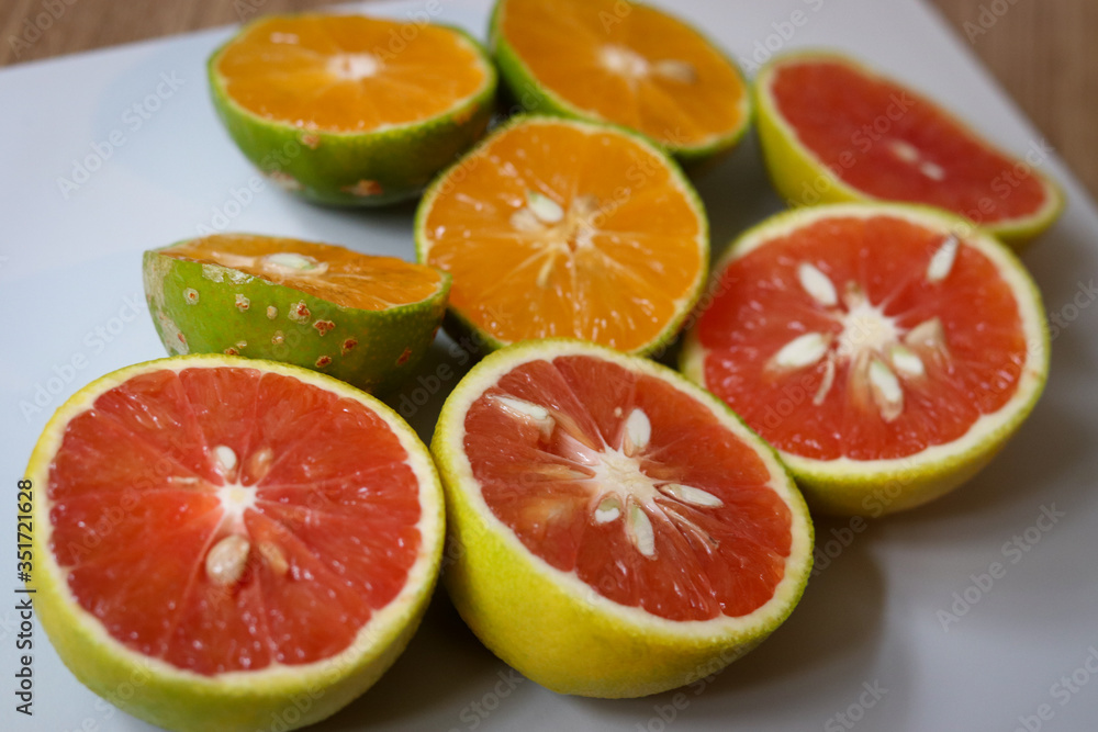 Beautiful lemons and grapefruits cut in half on a cutting board. Beautiful lemons and grapefruits cut in half on a cutting board.