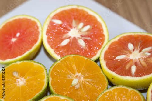 Beautiful lemons and grapefruits cut in half on a cutting board.