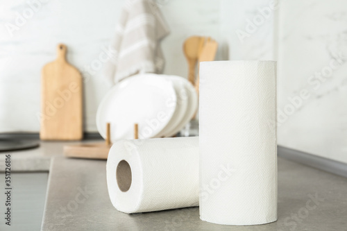 Rolls of paper towels on light grey table in kitchen