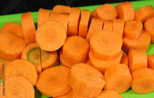 Beautiful carrots cut into slices on top of a cutting board. photo