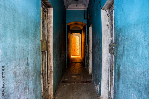Long empty corridor with blue walls in an old building  © PhotoChur