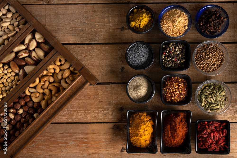 Mix of nuts and spices on a wooden table Mix of nuts and spices on a wooden table