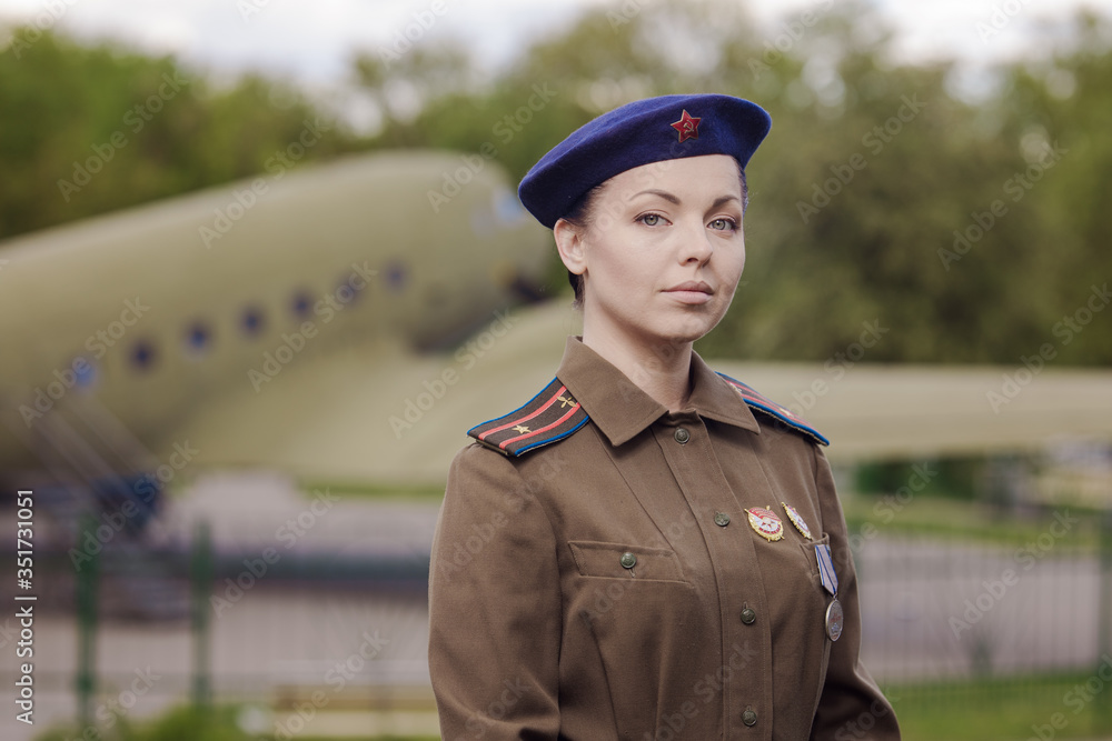 A young female pilot in uniform of Soviet Army pilots during the World ...