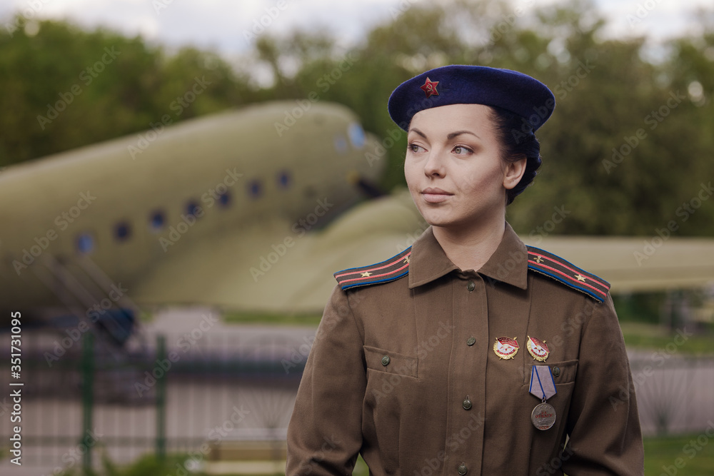 A young female pilot in uniform of Soviet Army pilots during the World ...
