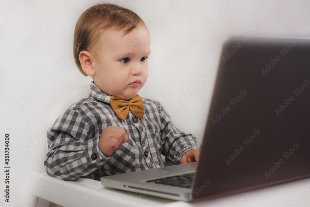 Little boy looking at laptop