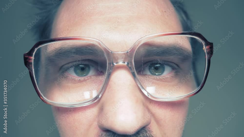 closeup. bald mustachioed man in glasses looks at the camera with curiosity closeup. bald mustachioed man in glasses looks at the camera with curiosity