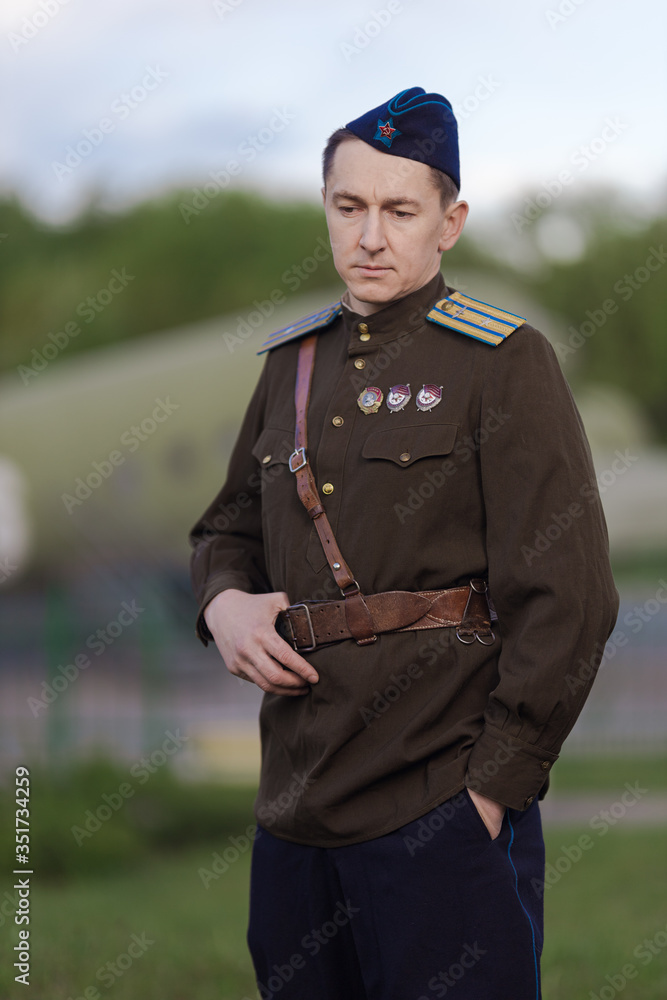 A young adult male pilot in the uniform of pilots of the Soviet Army of the